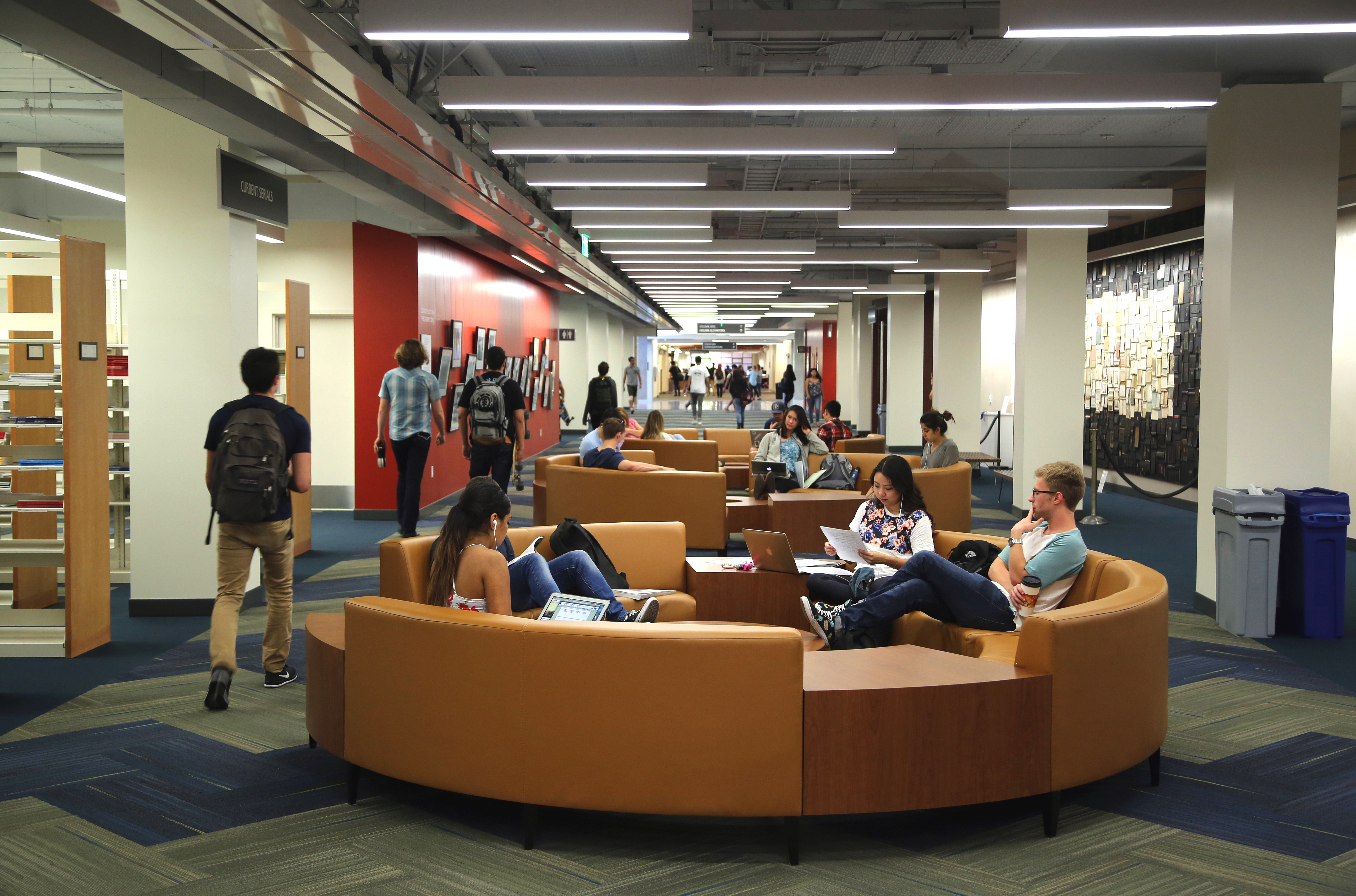 students sitting on circular couches in library