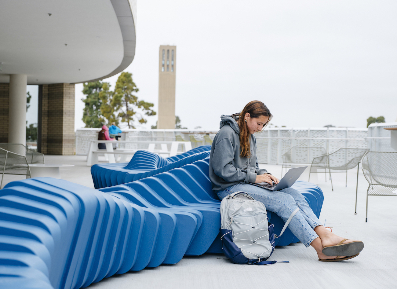 student studying on ILP balcony with Storke in background