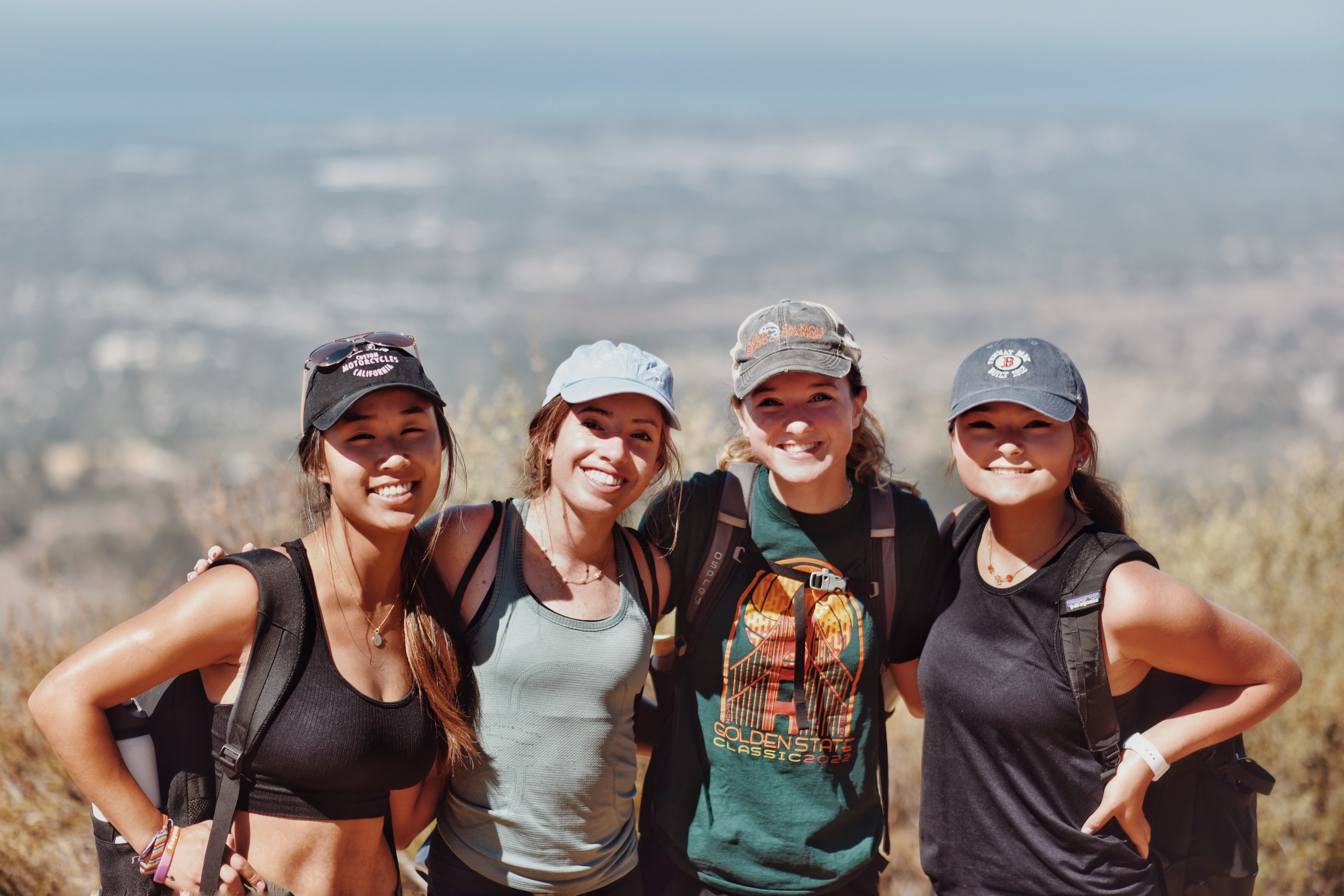 four students posing during a hike